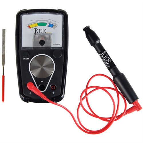 An image of a KEE gold and platinum tester with a black analog meter, a red testing plate, a file, and a pen probe